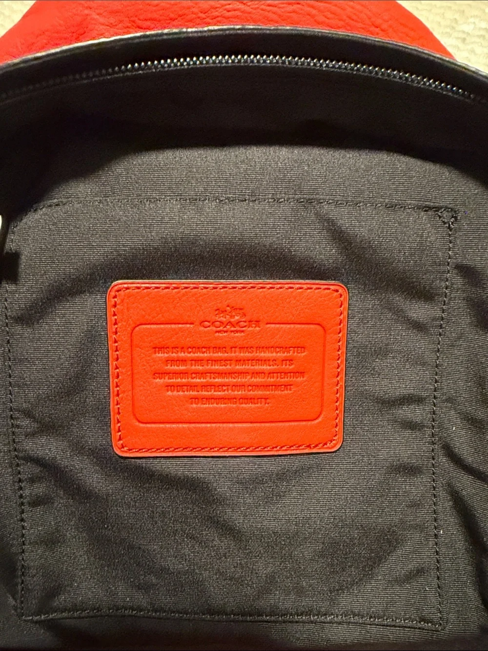 NWT Coach Orange Pebble Leather Crossbody Sling with Black Strap